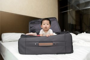 baby in suitcase; tips for maximizing baby sleep when traveling