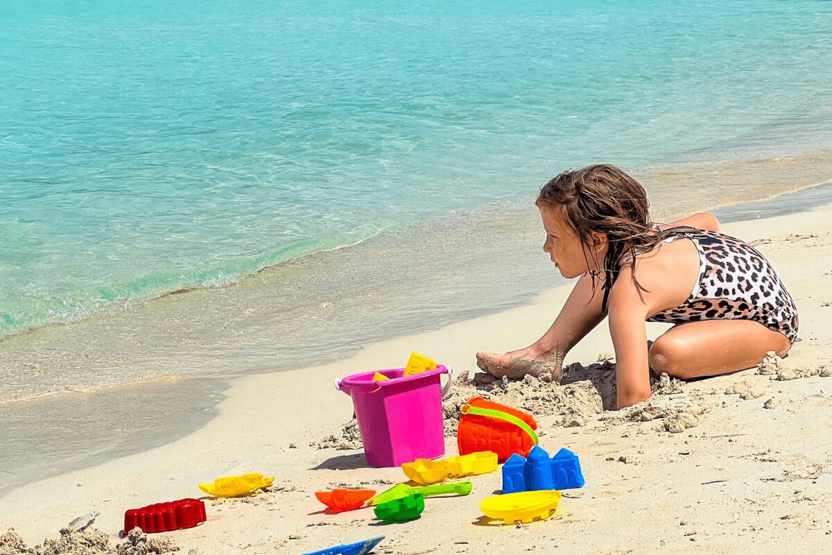 Toddler and toys at the beach