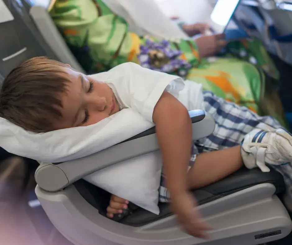 Little kid sleeping on airplane during easy family travel to Europe