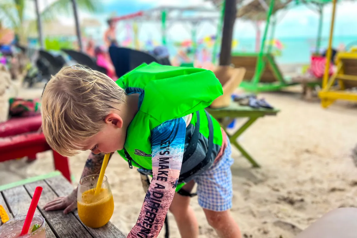 Child enjoying a drink on vacation